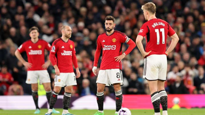 Manchester United players react after a Premier League match as the team faces pressure to improve its results.