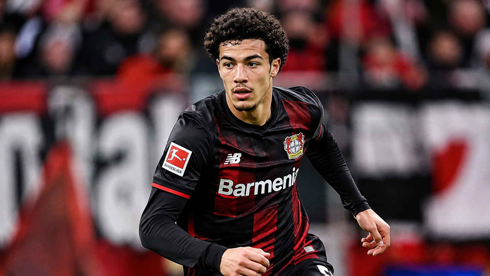 Ibrahim Maza of Bayer Leverkusen dribbles with the ball during a football match.