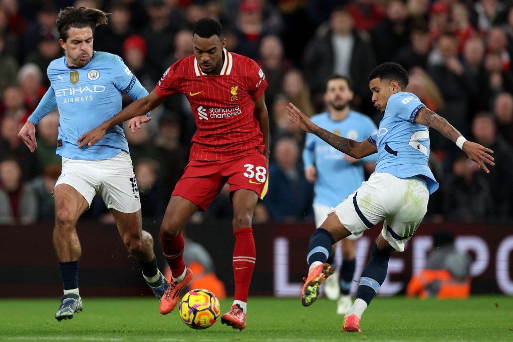 Liverpool midfielders compete for possession during a Premier League football match.